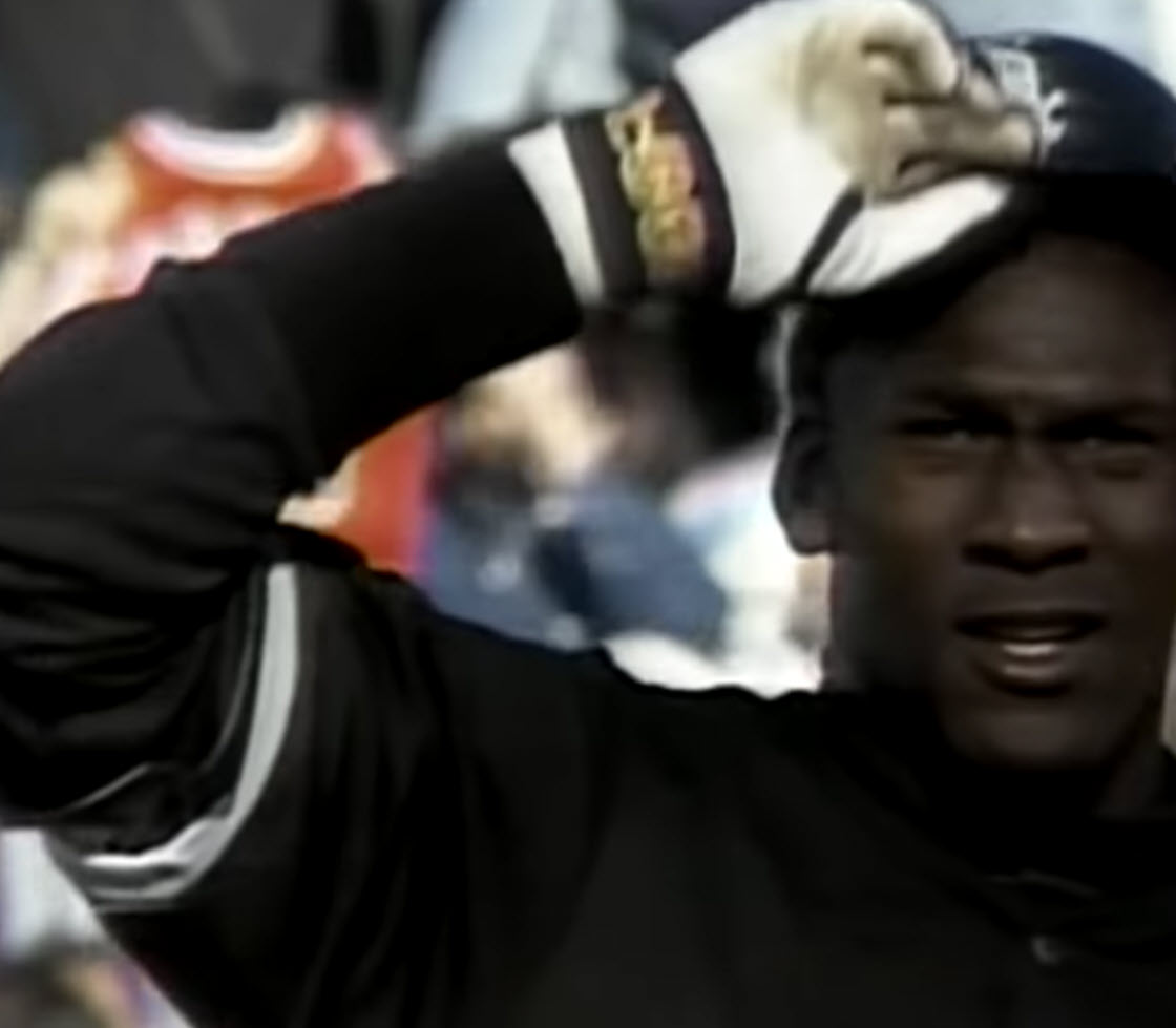Michael Jordan tipping his hat to the crowd at a baseball game